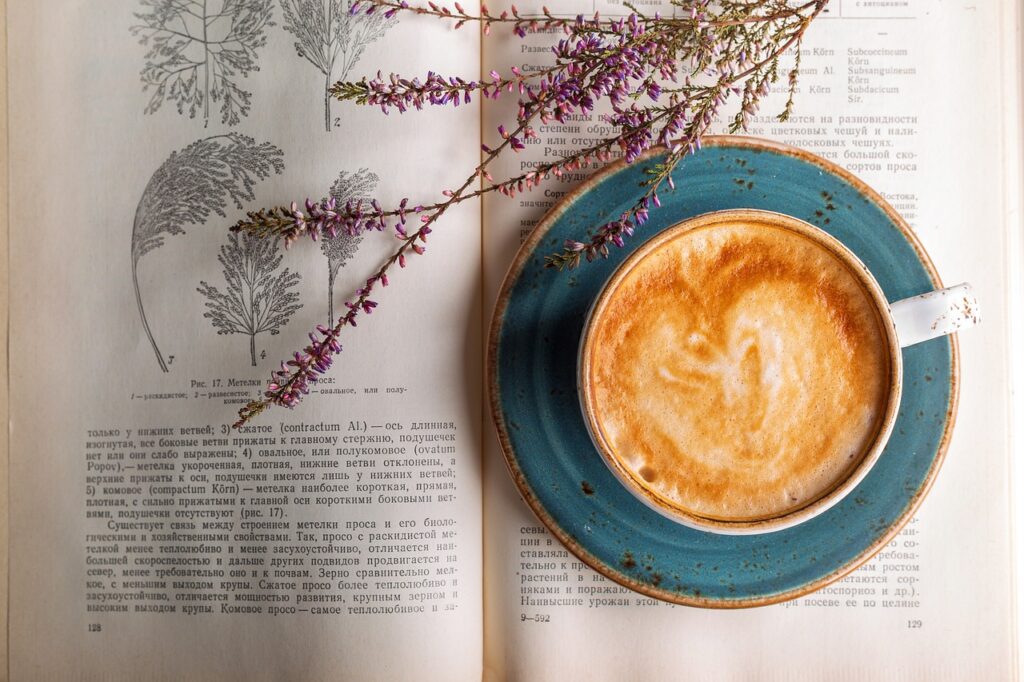 Coffee cup on top of a book with lavender.